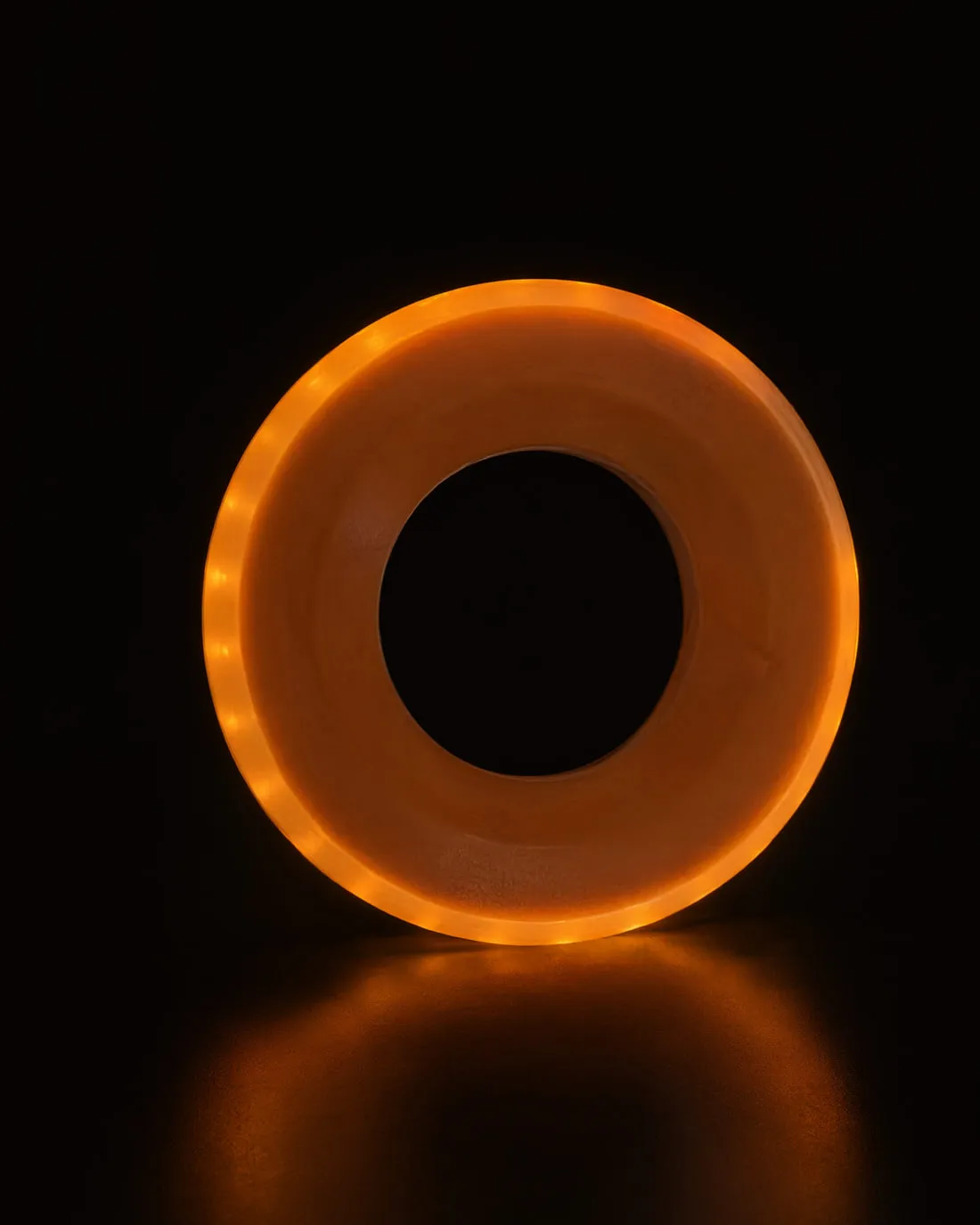 GLACILIT LED ringette ring glowing against a black background