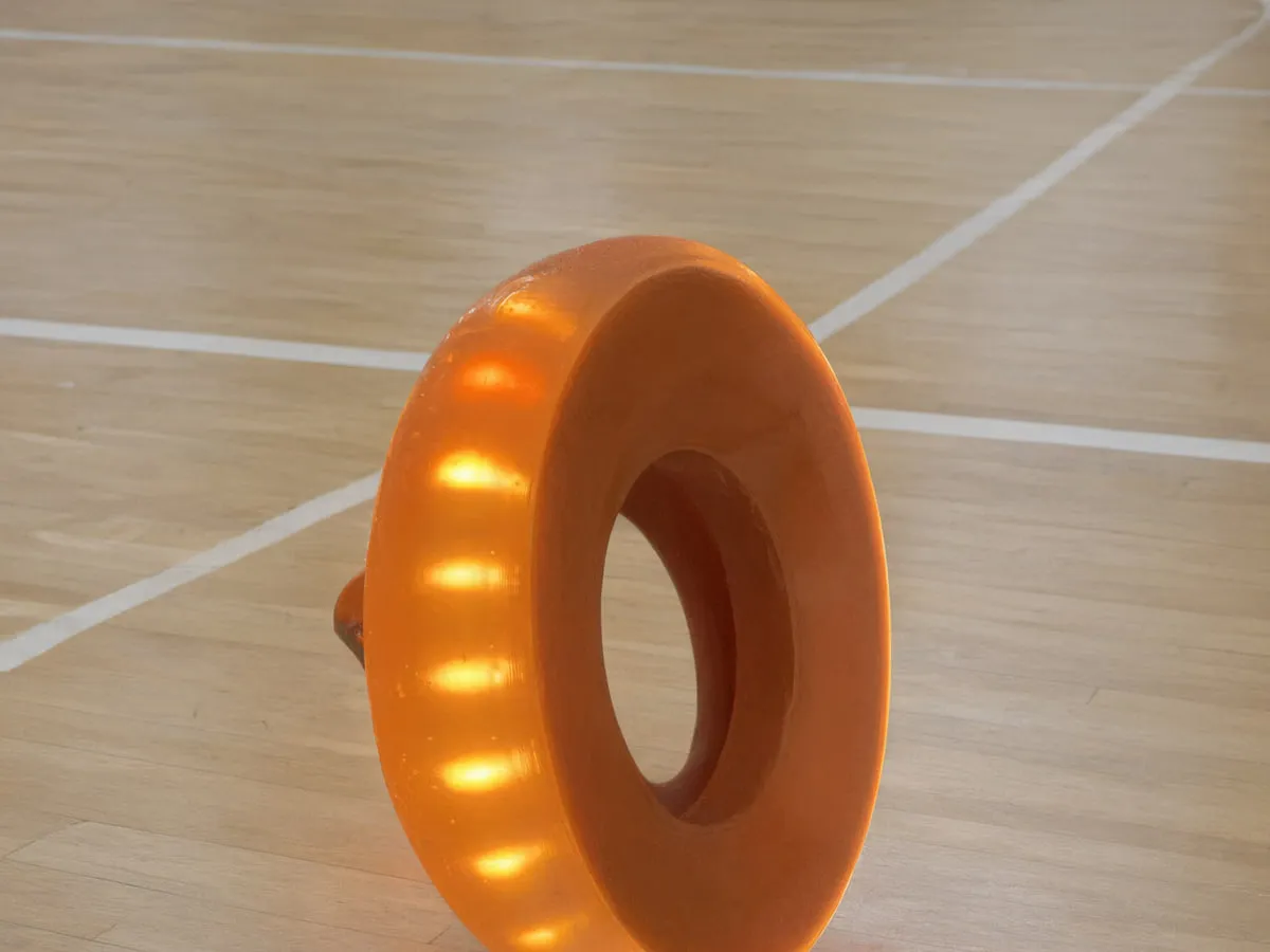 GLACILIT LED ringette ring glowing on a bright gym floor